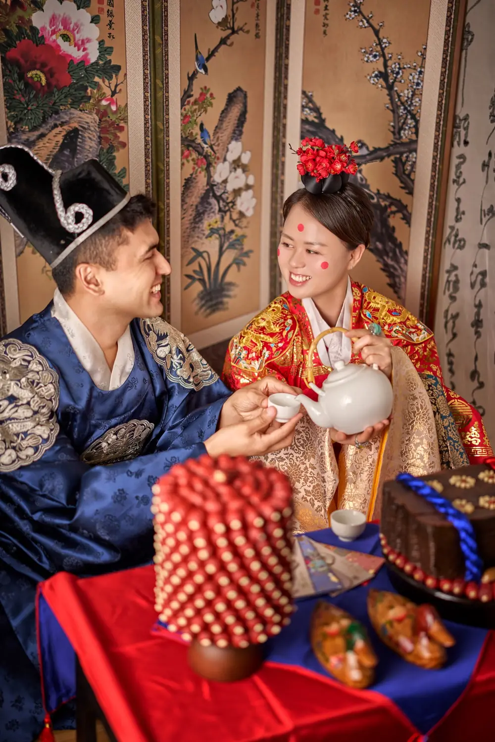 Ibrohim and Haniya wearing traditional Korean ceremonial clothing